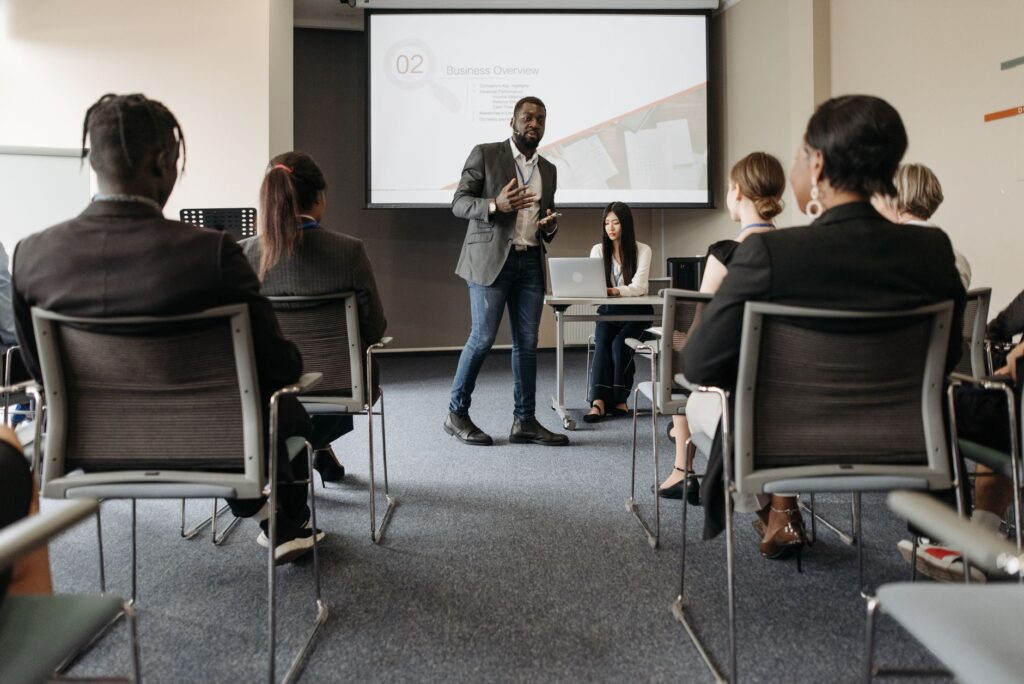 Staff attending a cybersecurity training session led by a presenter